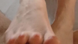 Kelly Performs a Technical Footjob Bringing Dominik's Cock to a Squirting Orgasm.