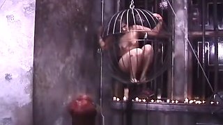 Two kinky mistresses take it out on a caged brunette slave