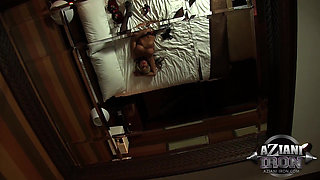 Blonde cougar Abby Marie fingers her pussy on bed while wearing fishnets