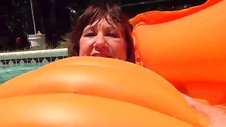 Grandma pleasures herself in the pool