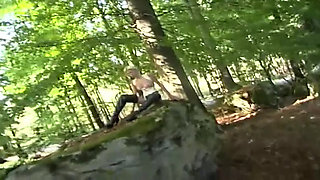 Lonely slave in fetish clothes walking in the woods