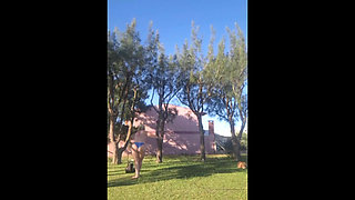 Stepmother in a bikini in the garden of the house makes a video for her stepson, to show off her new clothes.